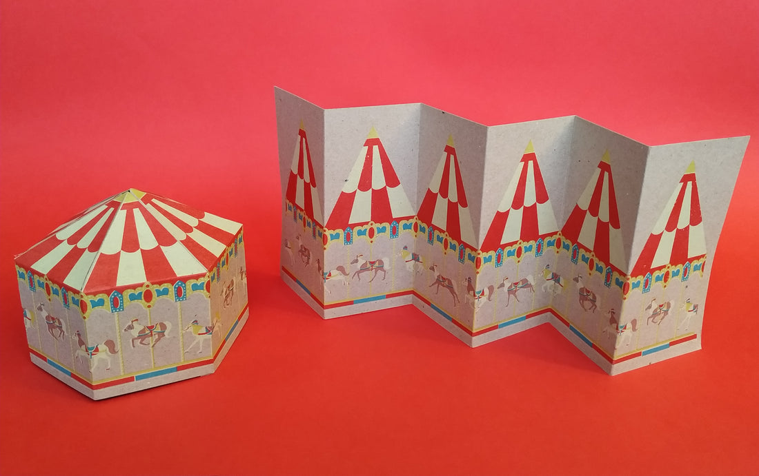 screenprint concertina carousel card and the same card next to it transformed into a carousel model, with a plain red background